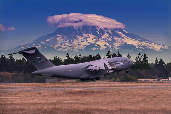 C-17 Globmaster III take-off with Mt. Rainier over...
