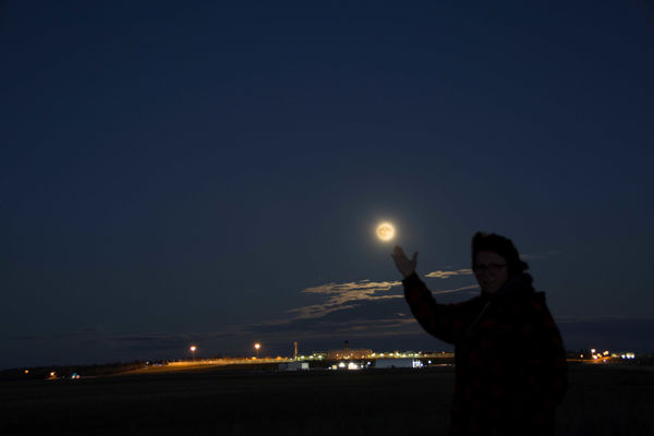 My wife touching the moon...