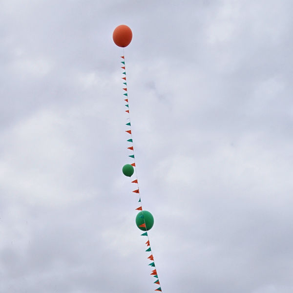 Balloons in a cloudy sky at a festival.........