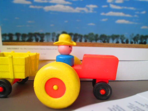 Weeble People Farmer on Tractor.  Background is "S...