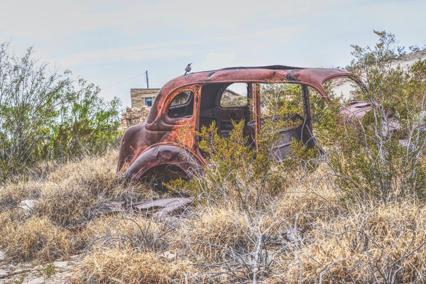 rusted out and stripped old jalopy...