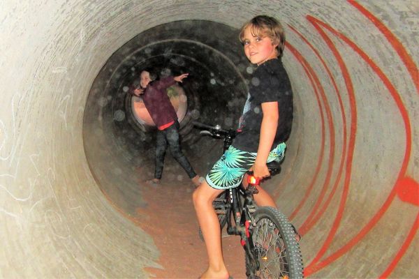 My grandkids in the tunnel under the train tracks ...