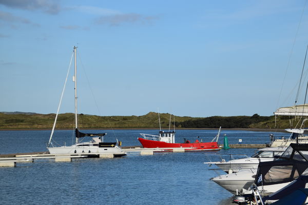 Red Boat stands out in Malahide Harbor, Ireland...