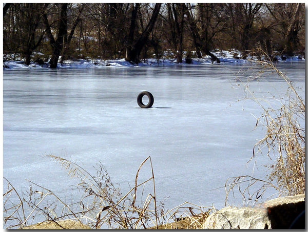 TIRE FROZEN IN ICE OF THE JAMES RIVER CANAL, RICHM...