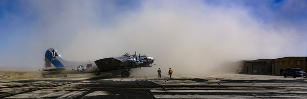 B-17 in a cloud of dust kicked up by the V-22...