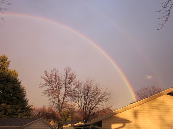 2 Rainbows to our East over neighbor's roofline...