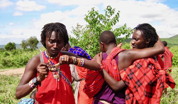 villagers celebrating manhood ceremony for young m...
