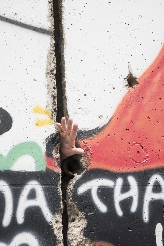 Someone reaching thru the Berlin wall....