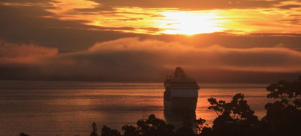 sunrise with one of the big liners anchoring in th...