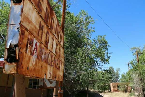 Abandoned hotel with rusty sign; New Mexico...