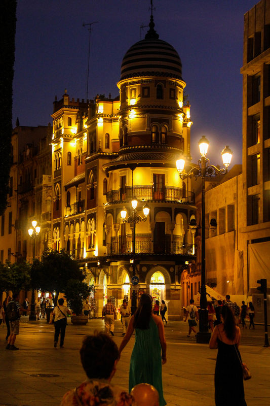 #10  A typical street scene in Seville after sunse...