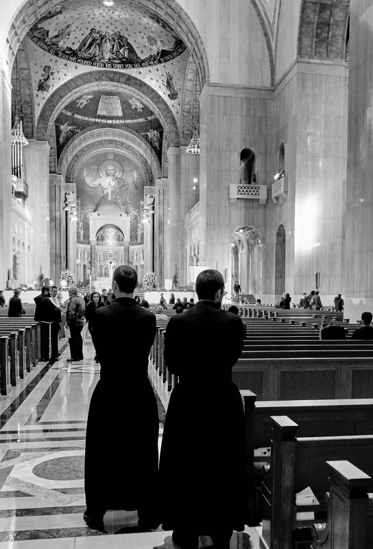 Two seminarians in the main aisle after Mass.  The...