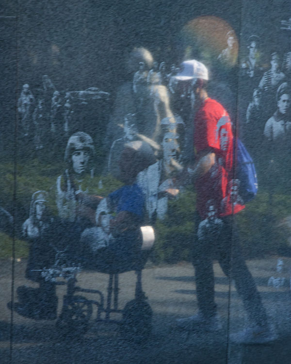 Reflection of wounded veteran helped by his guardi...