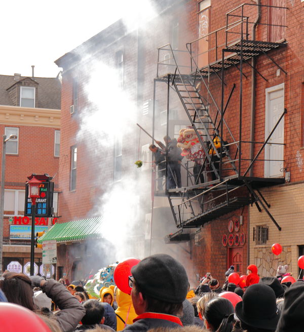 Large crowd with lion on fire escape...