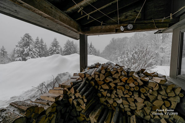 A wider angle view of the wood pile ... & snow plo...