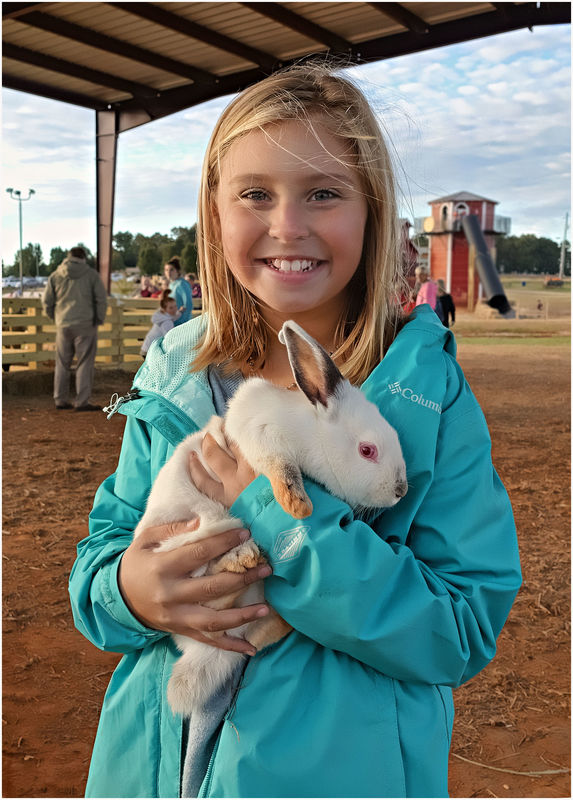 Girl and rabbit My twelve year old granddaughter at a farm festival in