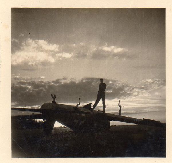 American airman atop downed Nazi fighter aircraft ...