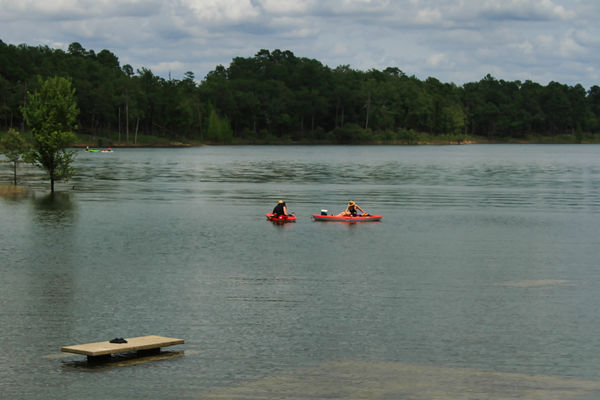 Kayaks on Broken Bow Lake there are some tables an...