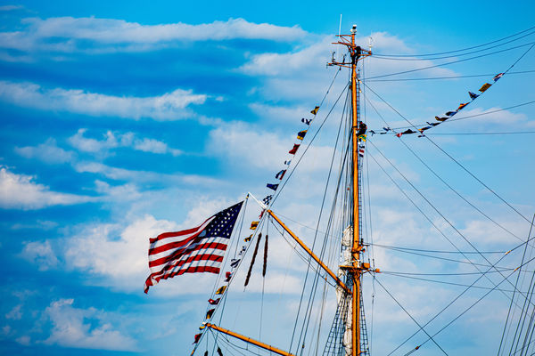 Old Glory with men on the mast...