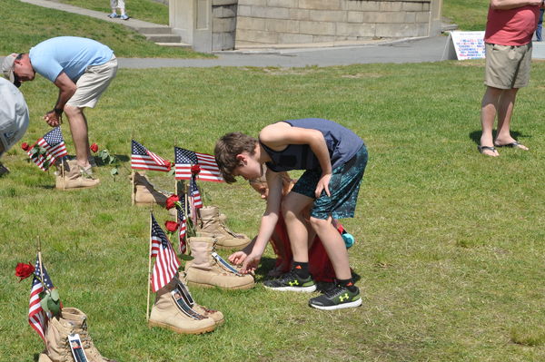 My grandkids placing penny on boot of a local...