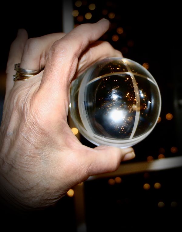 My hand fooling with crystal ball and photograph  ...