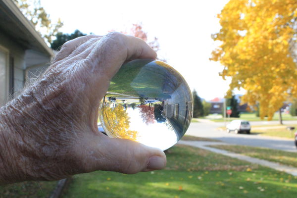 Holding a crystal sphere...