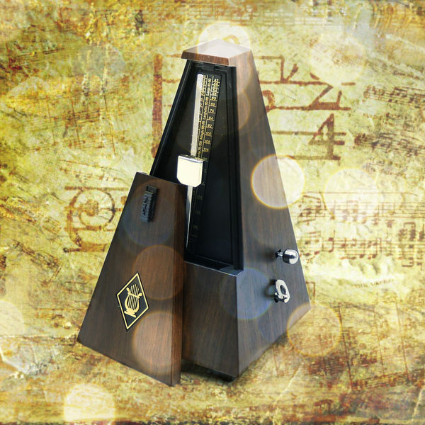 A Composite of an Old Metronome with Sheet Music a...