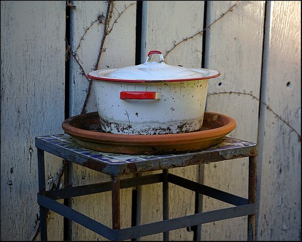 2. Old white pot on stand outside....