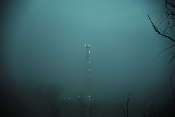 Drilling rig in early morning misty rain...