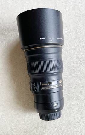 AF-S Nikkor Prime 300mm telephoto lens with hood. ...
