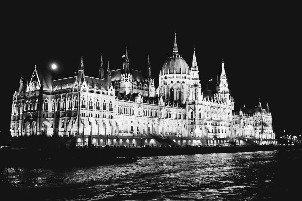 Moon rising over Hungarian Parliament in Budapest,...