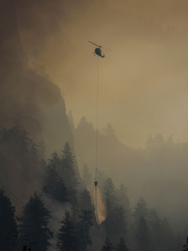 6. Helicopter dropping water on forest fire...