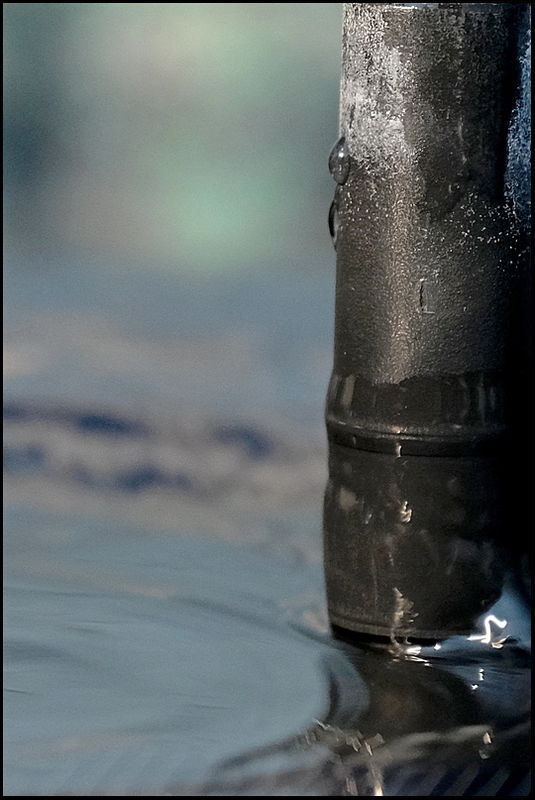 4. Closeup of spout on solar water fountain in bir...
