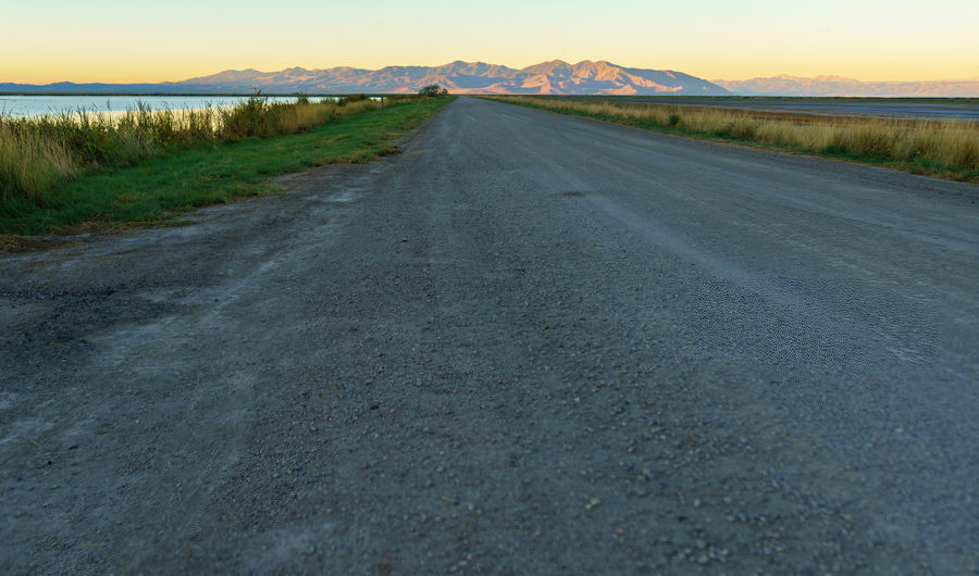Road next to the main pond with Antelope Island in...
