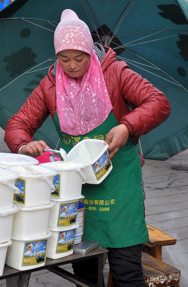 8 - Woman selling yoghurt made from yak-milk...