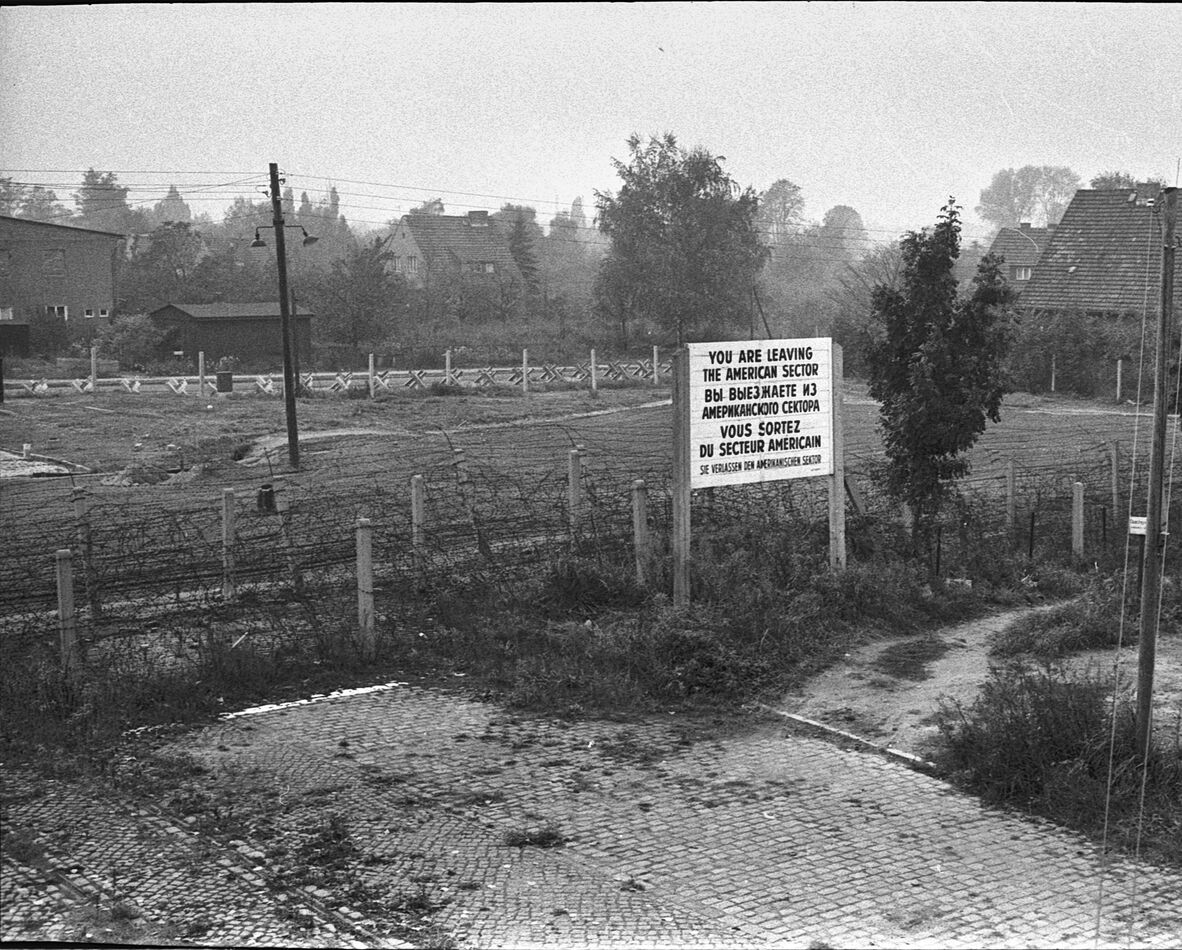 A road to what became East Berlin ending in barbed...