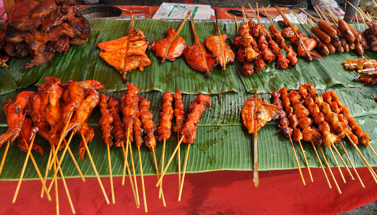 6 - Chicken satay on skewers and chicken pieces in...