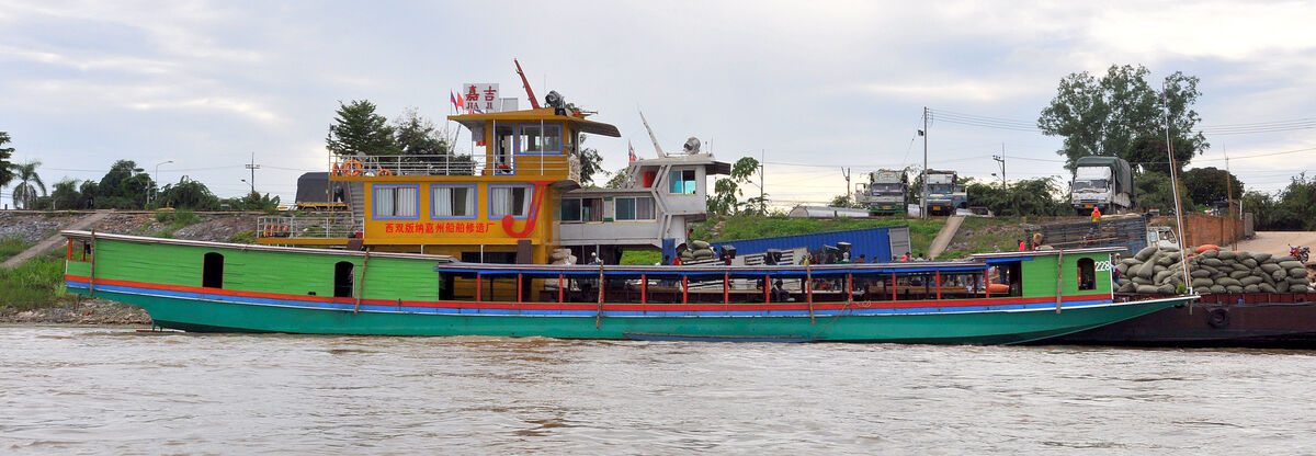 4 - Colorful large long-boat moored at the Thai sh...