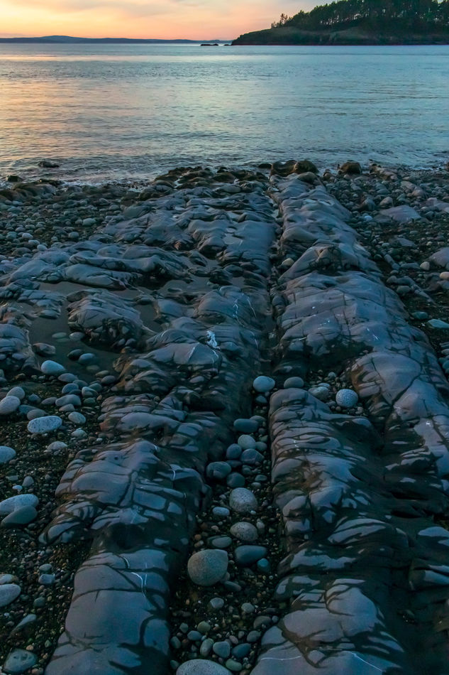 7.  This rock extends across the beach from the bo...