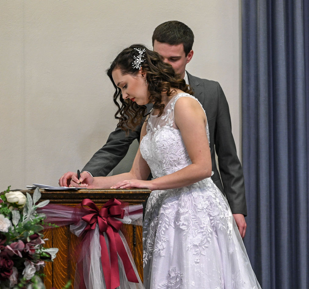 Signing the wedding certificate - the bride is fro...