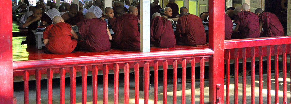 10 - Peeking in: Monks sitting on the floor in one...