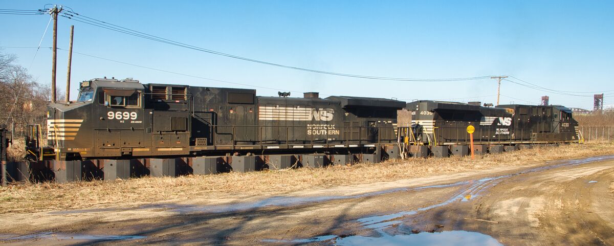 Two lead locos.  Two black structures on the right...