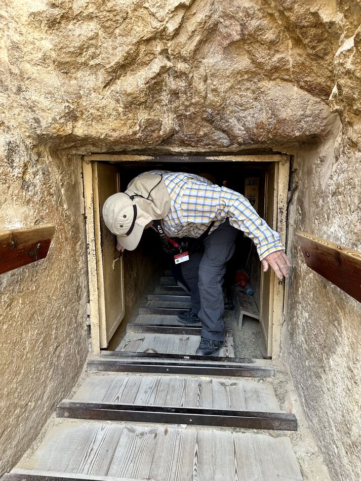 Climbing down the passage into the tomb. You have ...