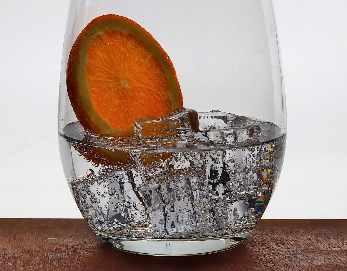 Glass of Soda Water with a slice of Orange and Ice...