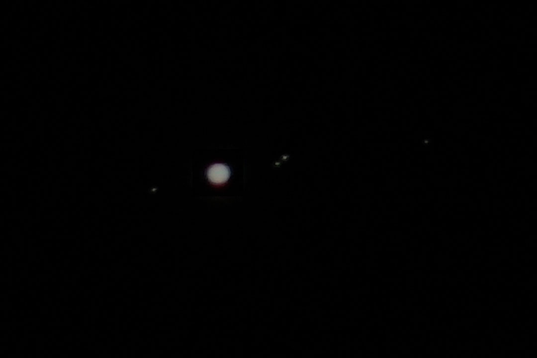 An image of Jupiter and four of its moons, taken i...