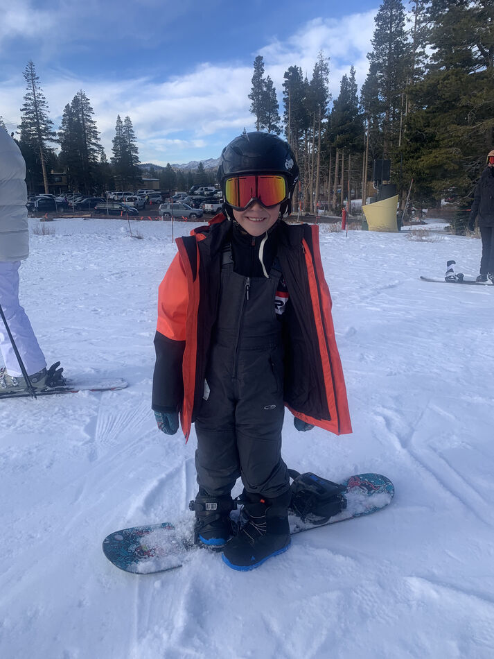 Youngest grand learning snow board technics...