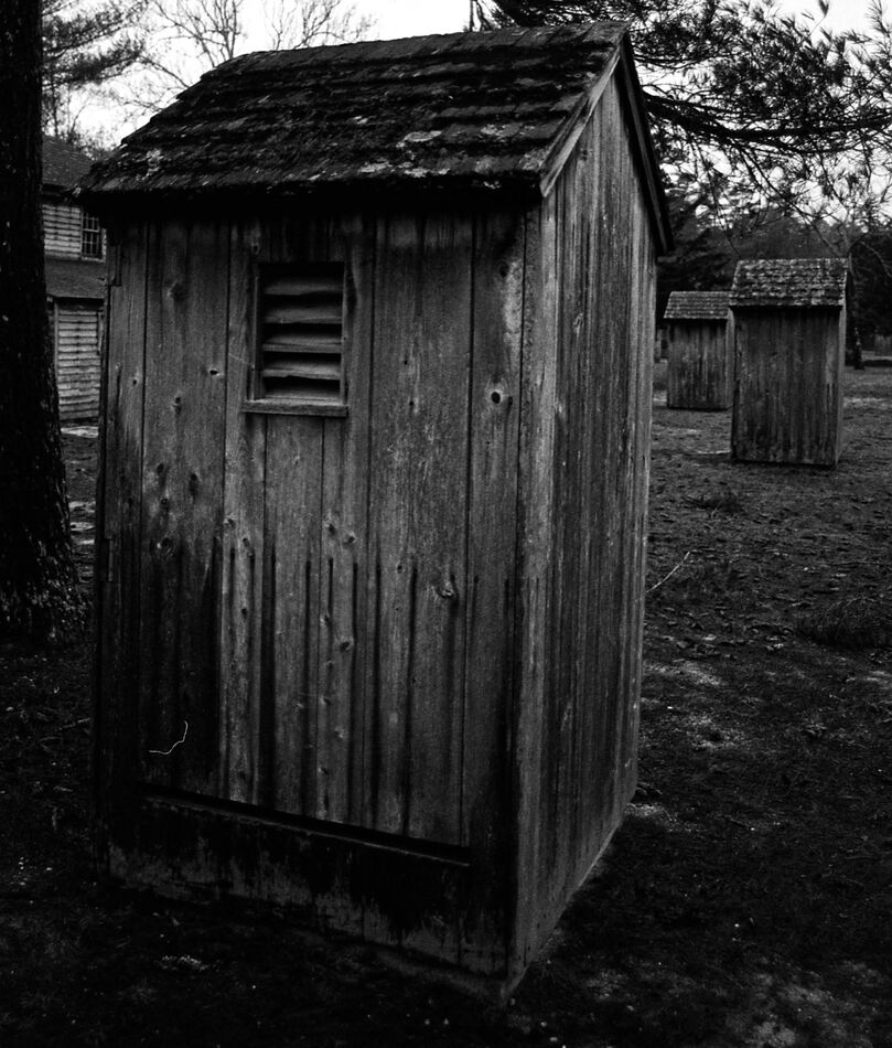 3 outhouses behind the worker's houses....