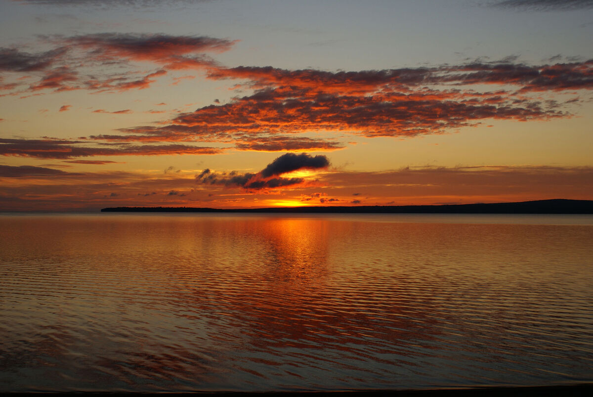 Sunrise over Keweenaw Bay, near Baraga, Michigan -...