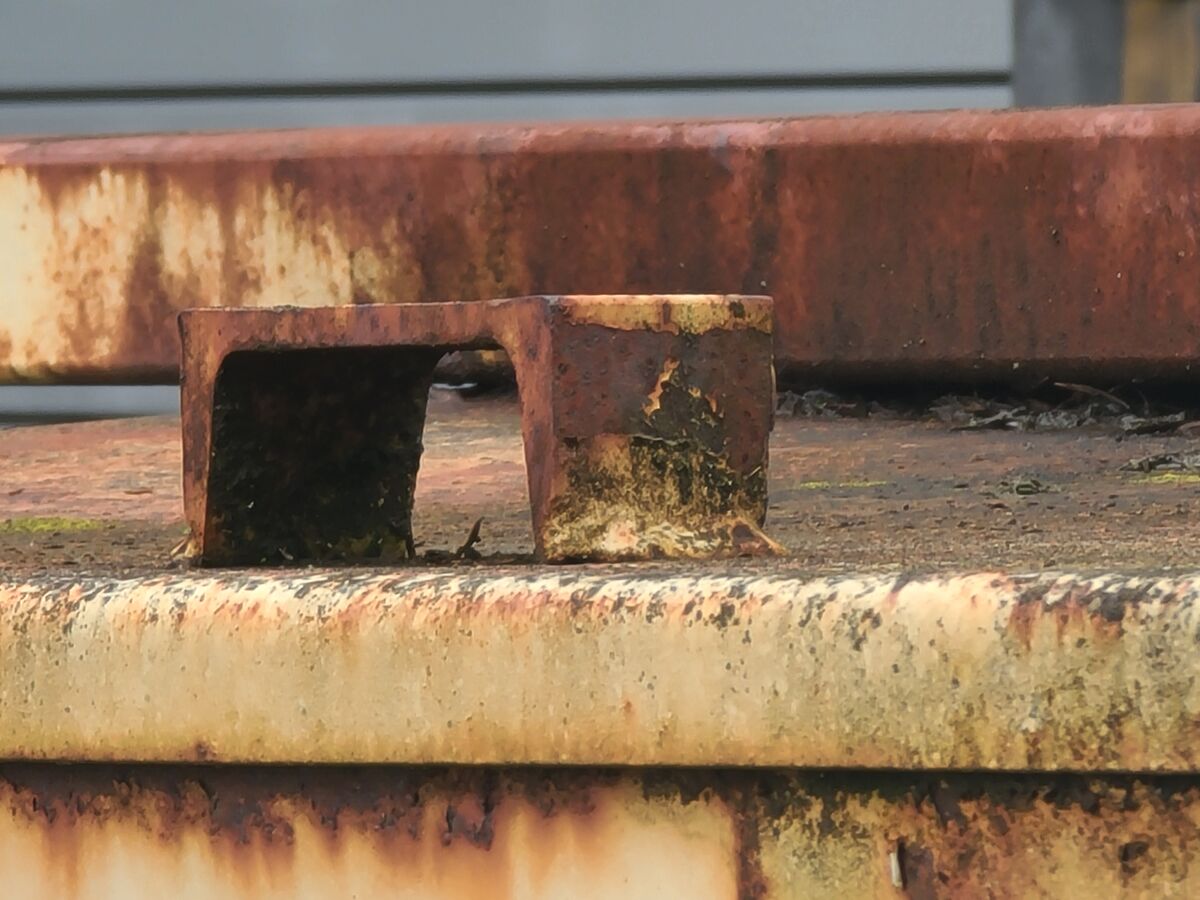 Part of a rusty dumpster top....