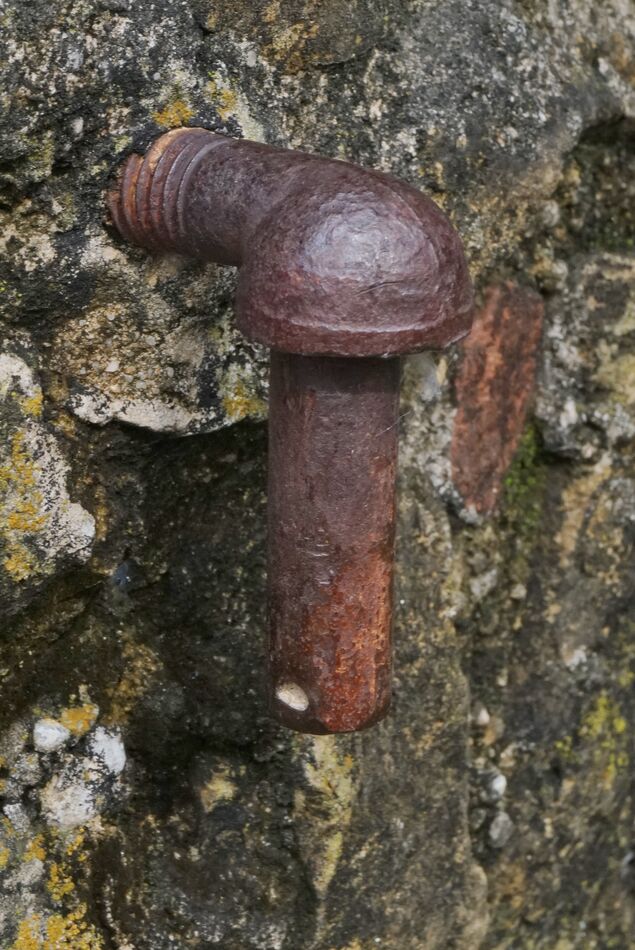 This piece of hardware imbedded in a rock masonry ...